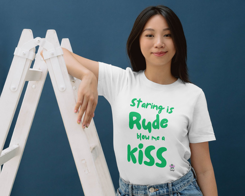 Person wearing a white T-shirt reading, "Staring is rude, blow me a kiss," promoting disability awareness.